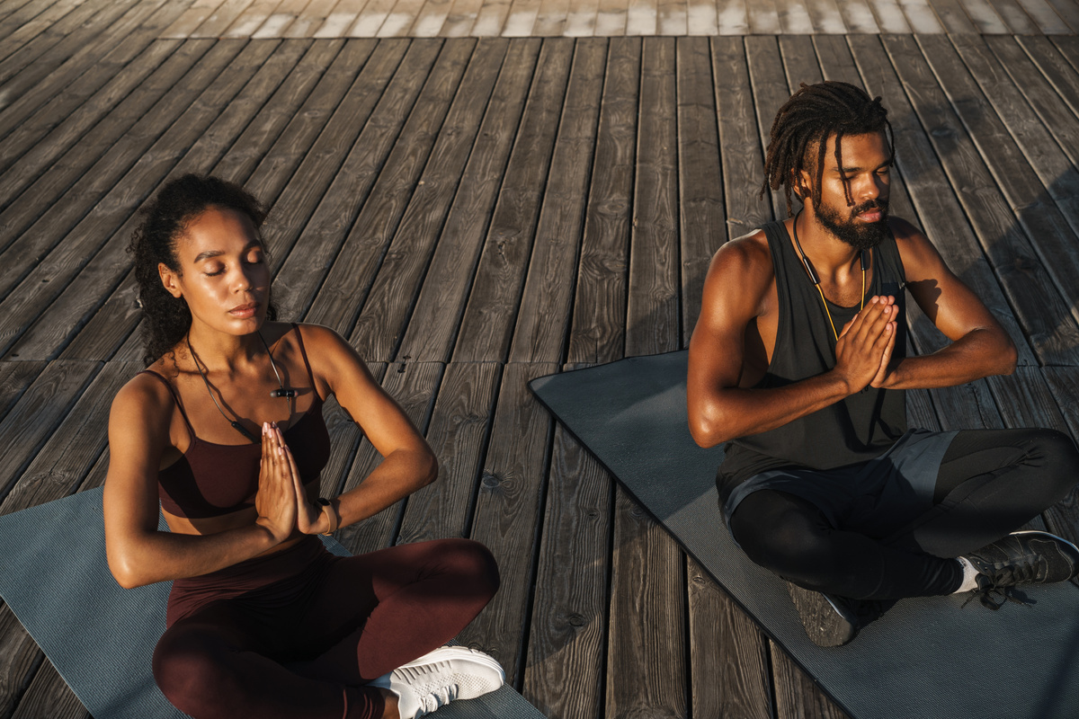 Calm Afro American Couple Doing Yoga Exercises